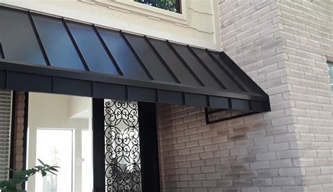 black metal awnings on a cream color house|Top 10 black metal awnings on house ideas and inspiration.